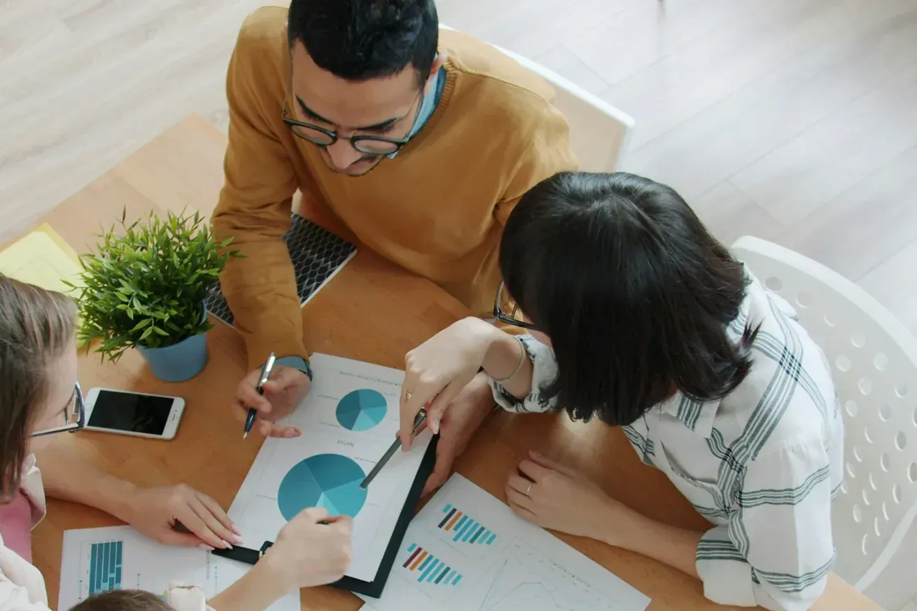 A team working together around a table covered in notes.